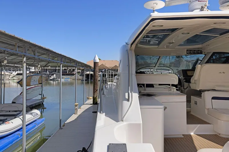 Slide: The Image of 2009 Sea Ray 470 Sundancer yacht docked at marina under clear blue sky. - 24
