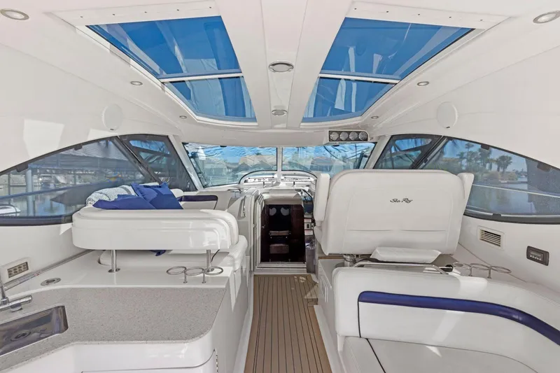 Slide: The Image of Interior of 2009 Sea Ray 470 Sundancer yacht with modern seating and blue skylights. - 29