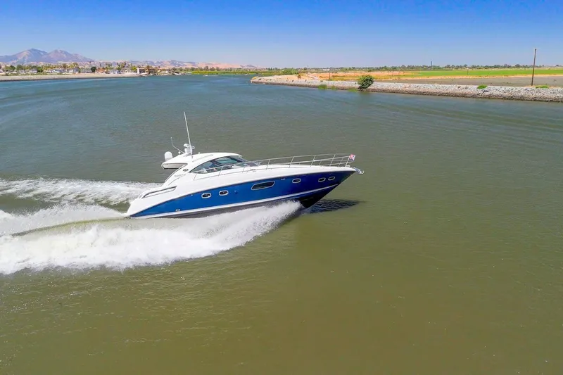 Slide: The Image of 2009 Sea Ray 470 Sundancer cruising on a scenic waterway under clear blue skies. - 3