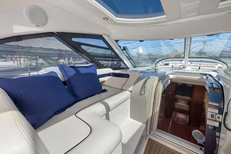 Slide: The Image of Luxurious interior of 2009 Sea Ray 470 Sundancer yacht with plush seating and blue cushions. - 31