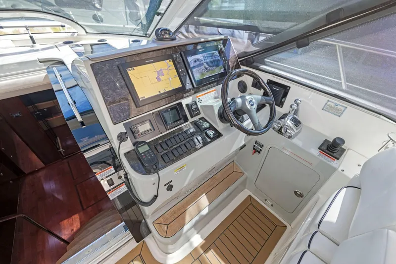 Slide: The Image of 2009 Sea Ray 470 Sundancer helm with navigation screens and controls. - 34