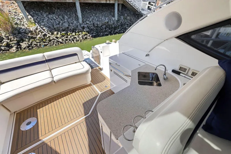 Slide: The Image of 2009 Sea Ray 470 Sundancer yacht deck with seating and kitchenette area. - 37