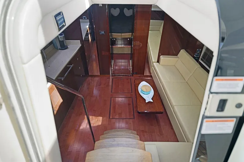 Slide: The Image of Interior of 2009 Sea Ray 470 Sundancer yacht with elegant wood flooring and beige seating. - 40