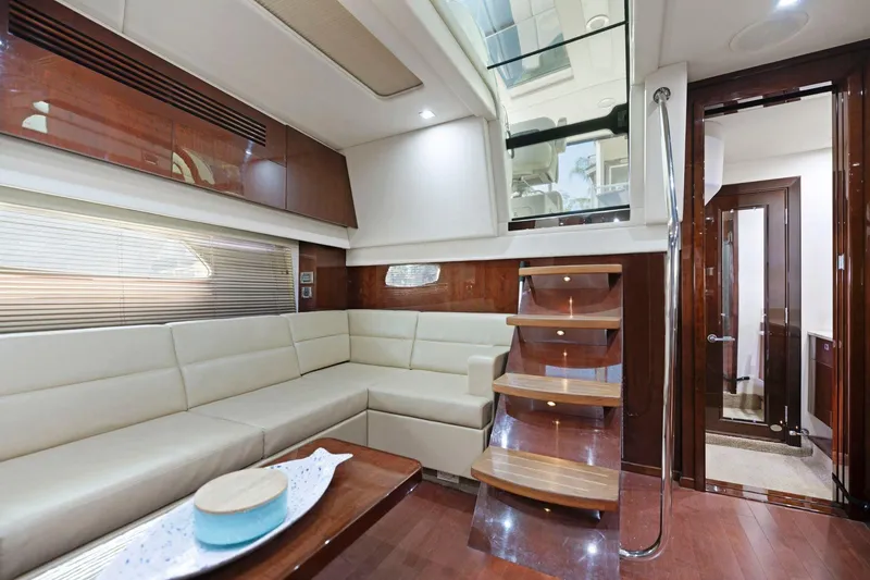 Slide: The Image of Luxurious interior of 2009 Sea Ray 470 Sundancer yacht with elegant seating and wooden accents. - 42