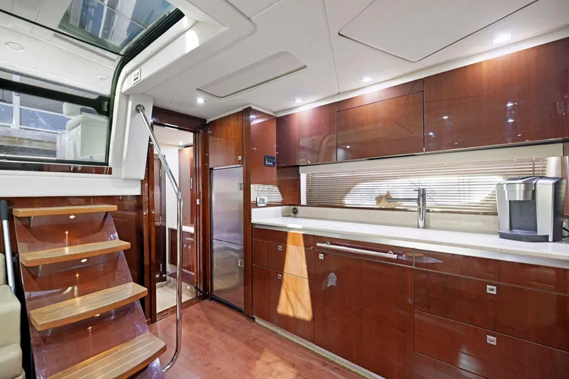 Slide: The Image of Luxurious interior of 2009 Sea Ray 470 Sundancer yacht with modern kitchen and wooden finishes. - 43
