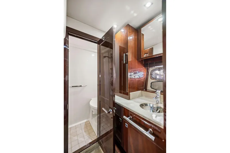 Slide: The Image of Luxurious bathroom in 2009 Sea Ray 470 Sundancer yacht with modern fixtures and wood accents. - 53