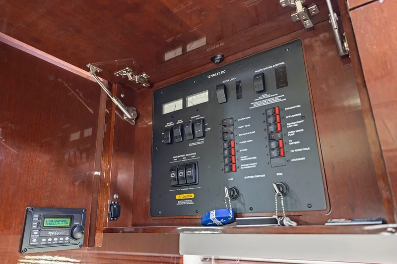 Slide: The Image of Electrical panel of 2009 Sea Ray 470 Sundancer yacht with control switches and gauges. - 56