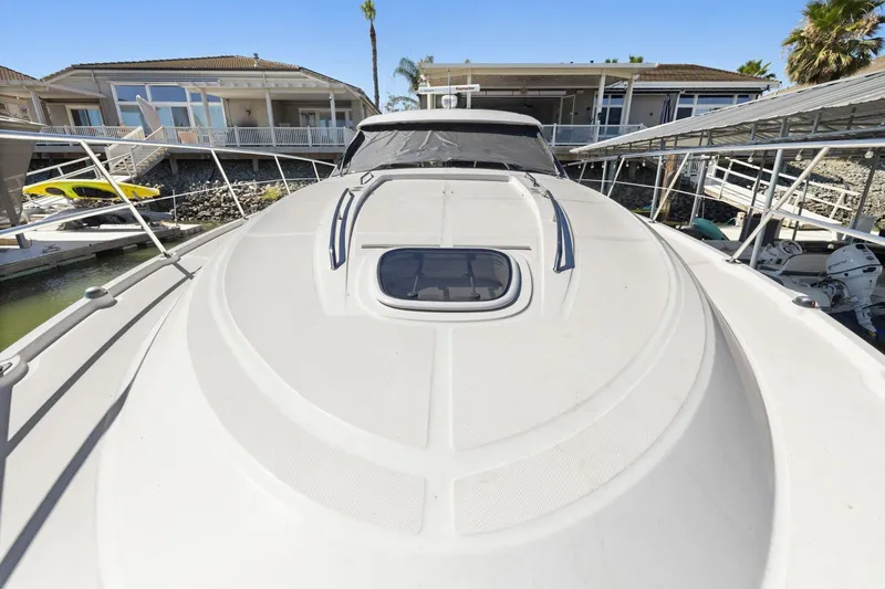 Slide: The Image of 2009 Sea Ray 470 Sundancer yacht docked at marina, showcasing sleek deck design. - 60