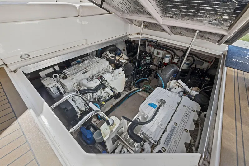 Slide: The Image of Engine compartment of 2009 Sea Ray 470 Sundancer yacht, showcasing Cummins engines. - 63