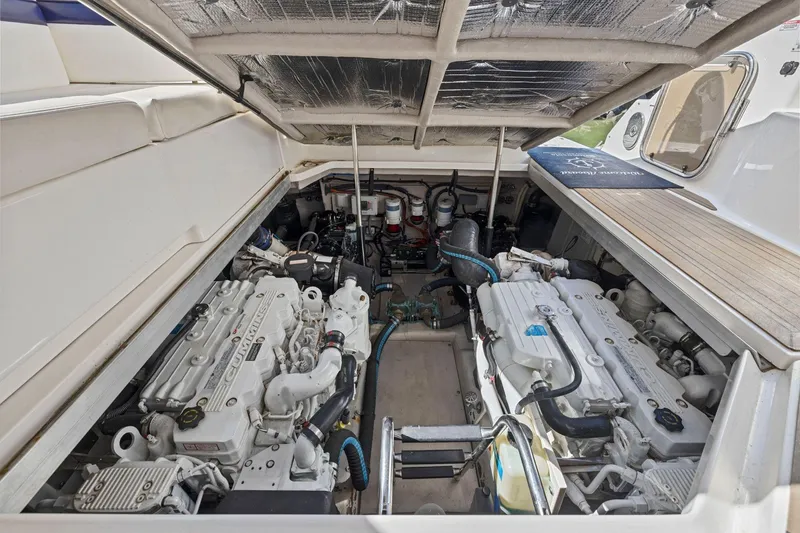 Slide: The Image of Engine compartment of 2009 Sea Ray 470 Sundancer yacht, showcasing dual Cummins engines. - 64