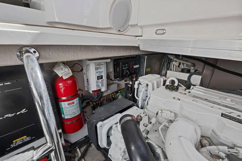 Slide: The Image of Engine room of 2009 Sea Ray 470 Sundancer with fire extinguisher and control panel. - 69