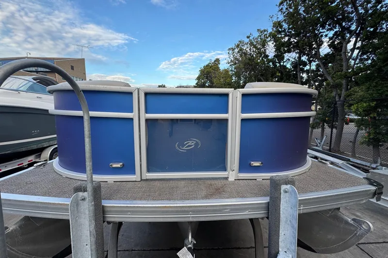 Slide: The Image of 2023 Barletta ARIA 22QC pontoon boat, blue exterior, docked outdoors. - 19