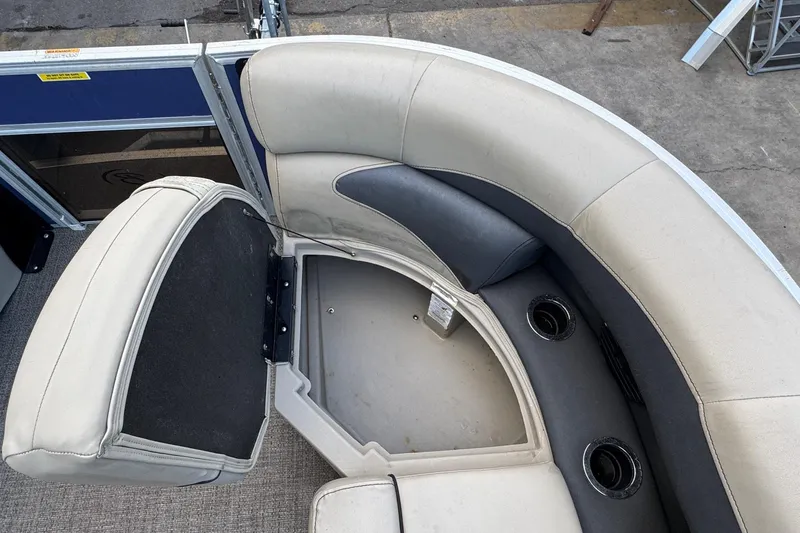 Slide: The Image of 2023 Barletta ARIA 22QC boat interior with beige seating and cup holders. - 32