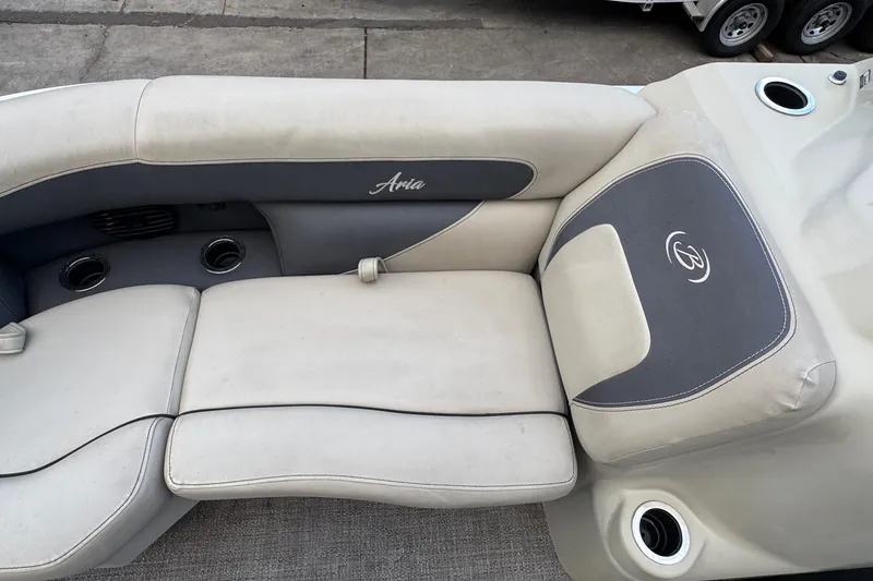 Slide: The Image of 2023 Barletta ARIA 22QC boat interior with cushioned seating and cup holders. - 34