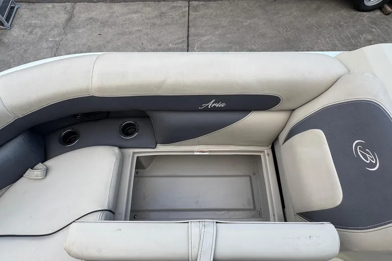 Slide: The Image of 2023 Barletta ARIA 22QC boat interior with storage compartment and cushioned seating. - 35