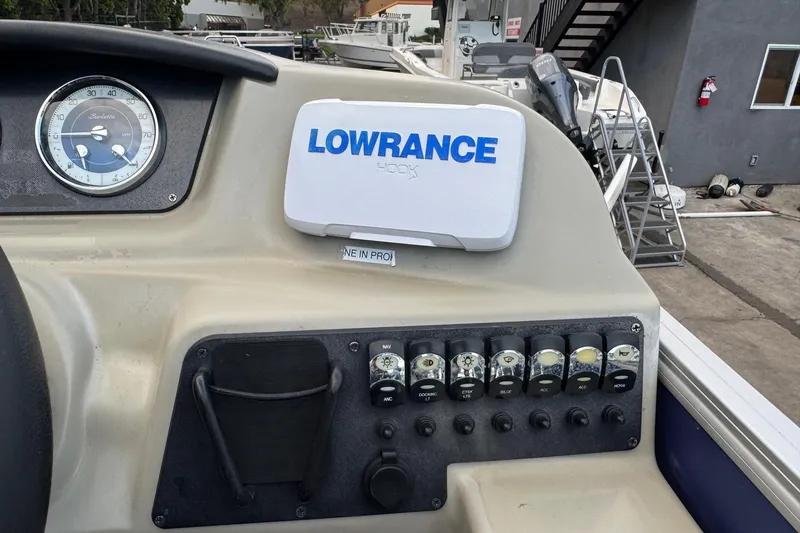 Slide: The Image of 2023 Barletta ARIA 22QC dashboard with Lowrance GPS and control panel. - 43