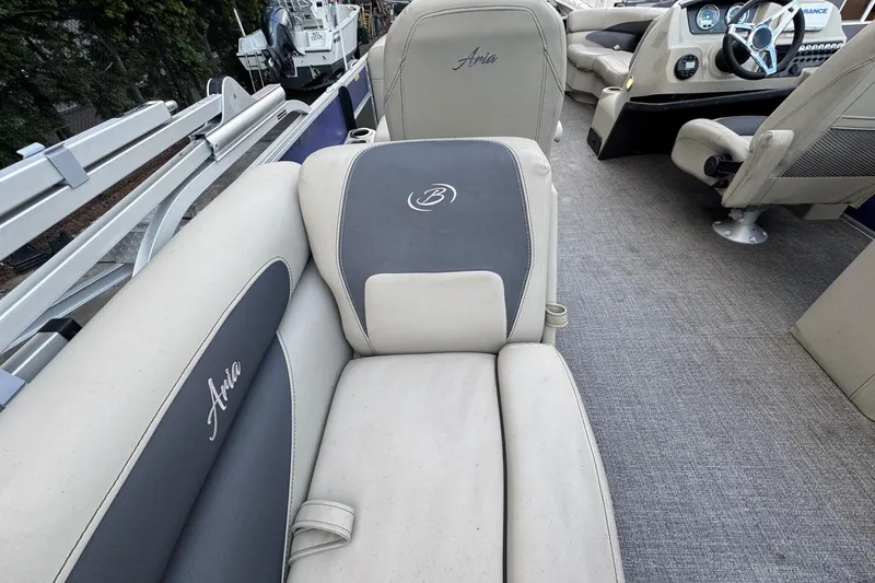 Slide: The Image of 2023 Barletta ARIA 22QC boat interior with plush seating and modern dashboard. - 53