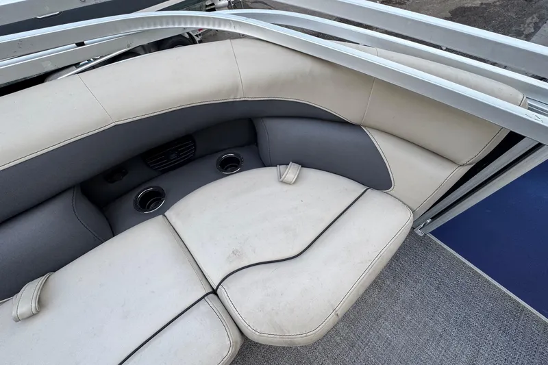 Slide: The Image of 2023 Barletta ARIA 22QC boat interior with cushioned seating and cup holders. - 65
