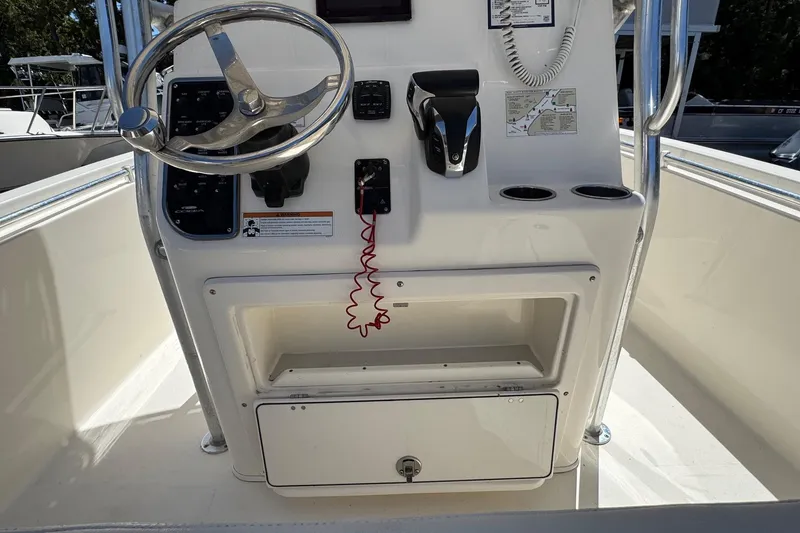 Slide: The Image of 2022 Cobia 237 Center Console boat interior with seating and storage compartments. - 16