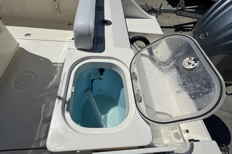 Slide: The Image of 2022 Cobia 237 Center Console boat interior with seating and storage compartments. - 18