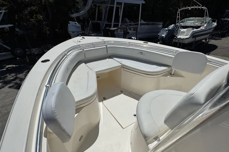 Slide: The Image of 2022 Cobia 237 Center Console boat dashboard with steering wheel and navigation equipment. - 20