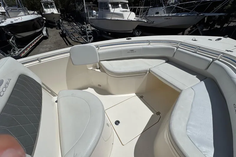 Slide: The Image of 2022 Cobia 237 Center Console boat interior with rod holders and storage compartments. - 22