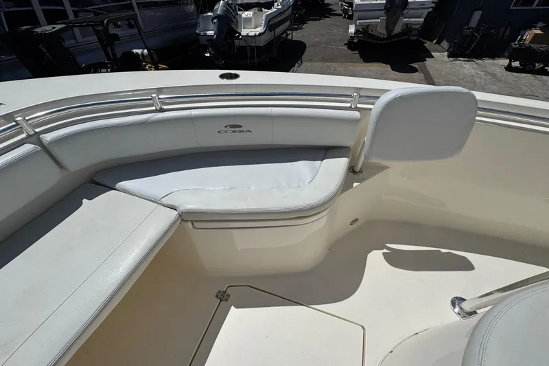 Slide: The Image of 2022 Cobia 237 Center Console boat with open livewell and seating. - 23