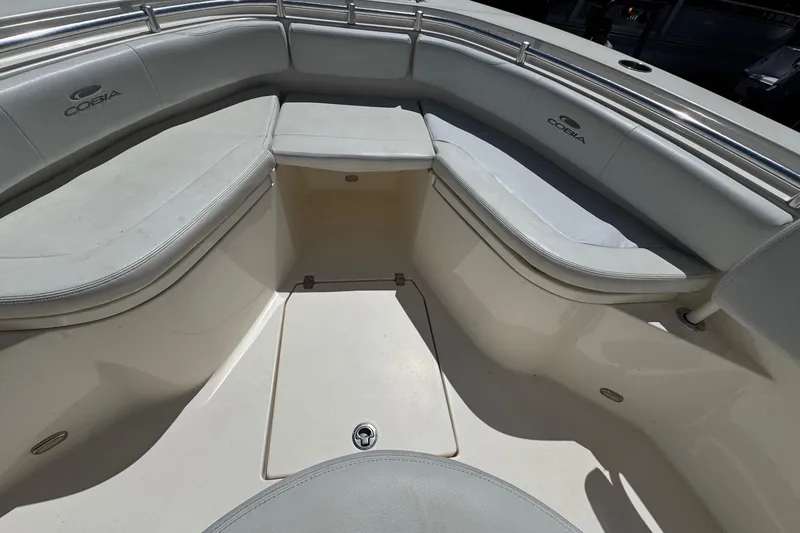 Slide: The Image of 2022 Cobia 237 Center Console boat interior with cushioned seating and storage. - 30