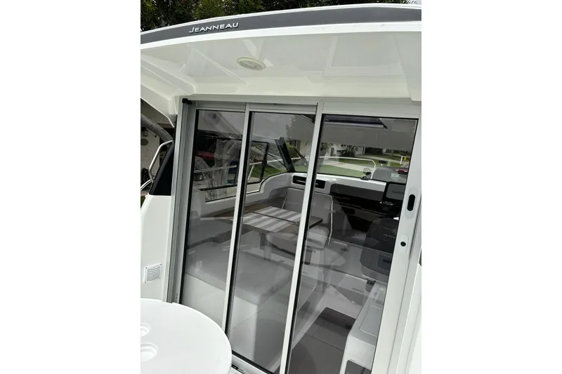 Slide: The Image of 2023 Jeanneau NC Weekender 695 Series 2 interior with sliding glass doors. - 10