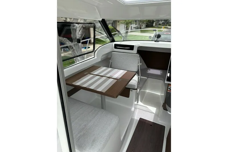 Slide: The Image of Interior of 2023 Jeanneau NC Weekender 695 Series 2, featuring seating and table. - 12