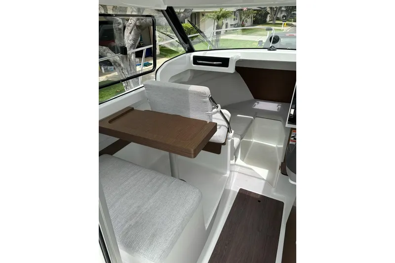 Slide: The Image of 2023 Jeanneau NC Weekender 695 Series 2 interior with seating and table. - 14