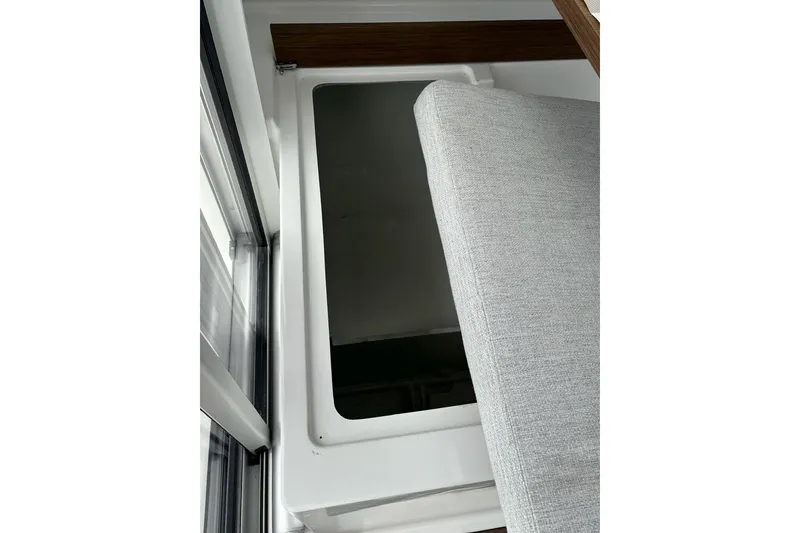 Slide: The Image of Interior view of 2023 Jeanneau NC Weekender 695 Series 2 with a window and cushion. - 27