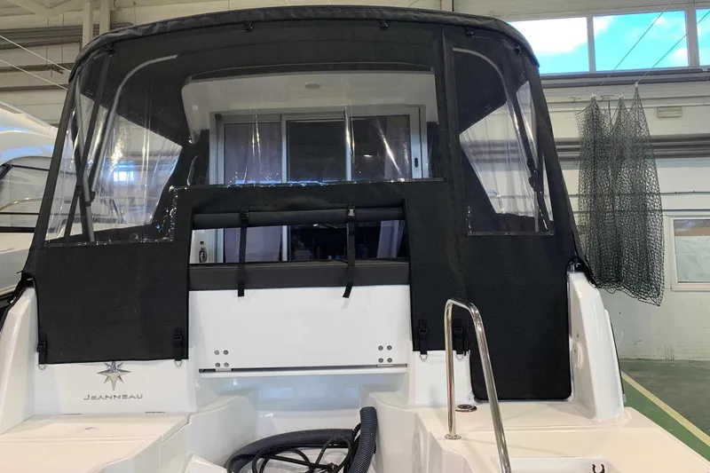 Slide: The Image of 2023 Jeanneau NC Weekender 695 Series 2 boat with black canopy in a showroom. - 34