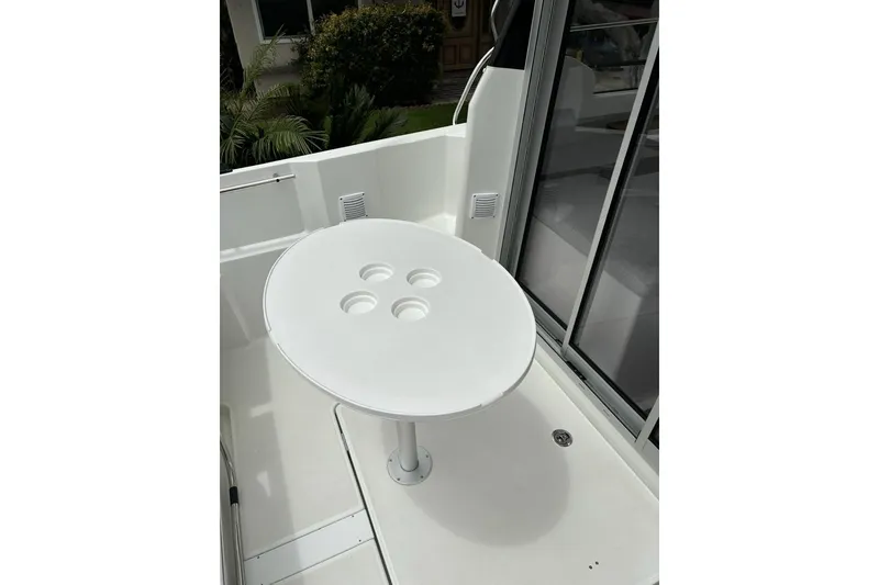 Slide: The Image of 2023 Jeanneau NC Weekender 695 Series 2 boat with a round outdoor table. - 9