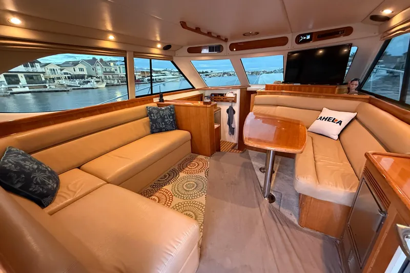 Slide: The Image of Luxurious interior of 2001 Riviera 40 Flybridge yacht with leather seating and waterfront view. - 10