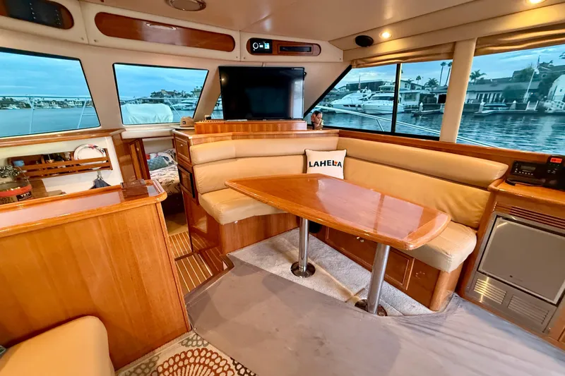Slide: The Image of Luxurious 2001 Riviera 40 Flybridge yacht interior with wood finishes and waterfront view. - 13