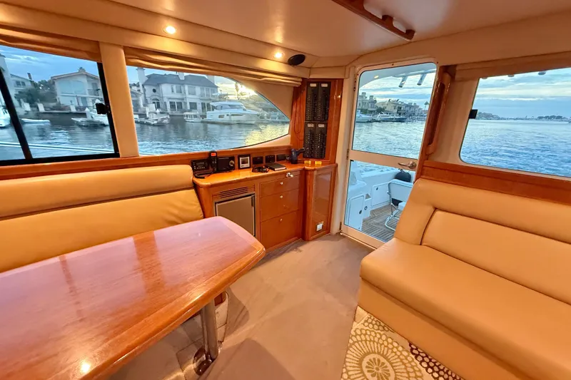 Slide: The Image of Luxurious interior of 2001 Riviera 40 Flybridge yacht with waterfront view. - 15
