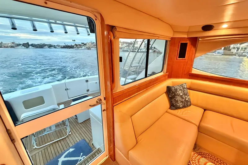 Slide: The Image of Interior of 2001 Riviera 40 Flybridge yacht with leather seating and ocean view. - 19