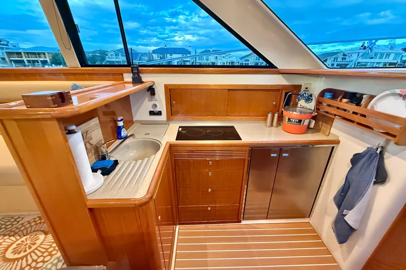 Slide: The Image of 2001 Riviera 40 Flybridge yacht kitchen with wood cabinetry, sink, and modern appliances. - 22