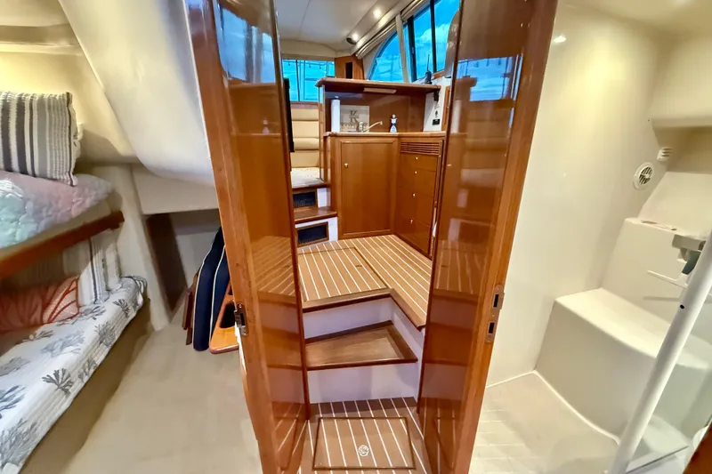 Slide: The Image of Interior of 2001 Riviera 40 Flybridge yacht with wooden stairs and cozy cabin. - 25
