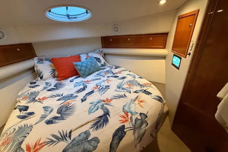 Slide: The Image of Cozy bedroom in 2001 Riviera 40 Flybridge yacht with floral bedding and wood accents. - 31