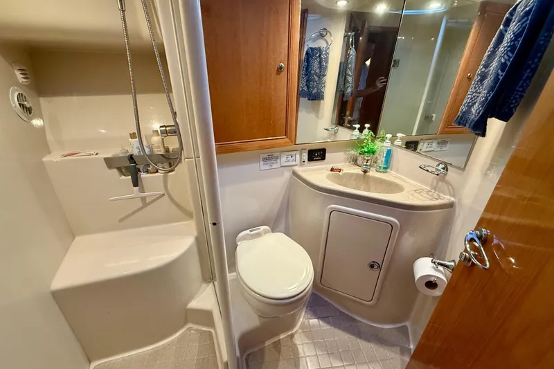 Slide: The Image of Bathroom interior of 2001 Riviera 40 Flybridge yacht, featuring shower, sink, and toilet. - 33