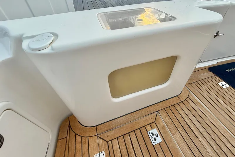 Slide: The Image of Riviera 40 Flybridge 2001 yacht deck with teak flooring and storage compartment. - 39