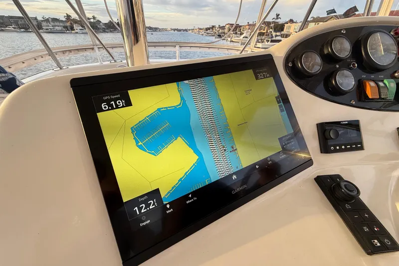 Slide: The Image of 2001 Riviera 40 Flybridge helm with Garmin navigation display, showing speed and depth. - 46