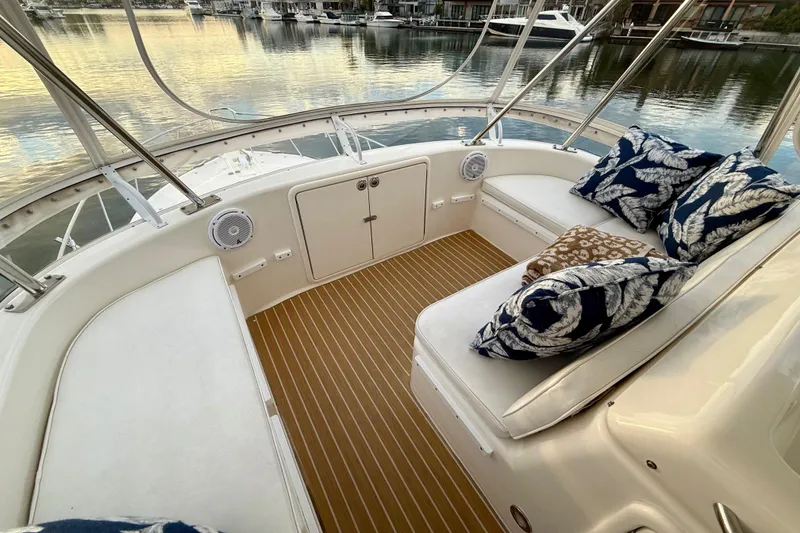 Slide: The Image of 2001 Riviera 40 Flybridge interior with cushioned seating and decorative pillows. - 48