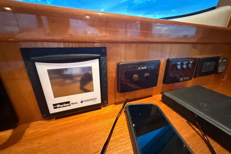 Slide: The Image of Control panel of a 2001 Riviera 40 Flybridge yacht with electronic displays and switches. - 59