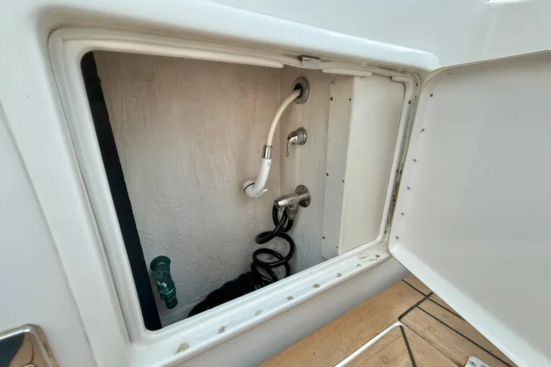 Slide: The Image of Storage compartment with hoses on a 2001 Riviera 40 Flybridge boat. - 61