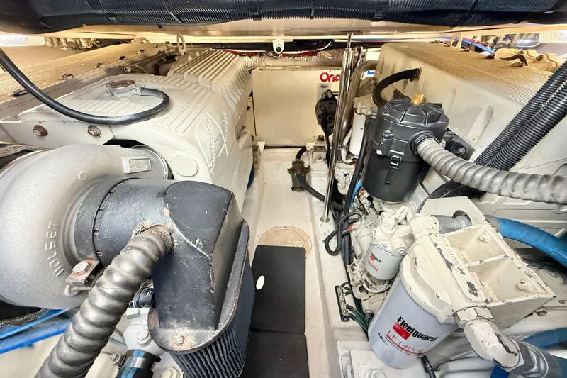 Slide: The Image of Engine room of a 2001 Riviera 40 Flybridge yacht, showcasing mechanical components and systems. - 63