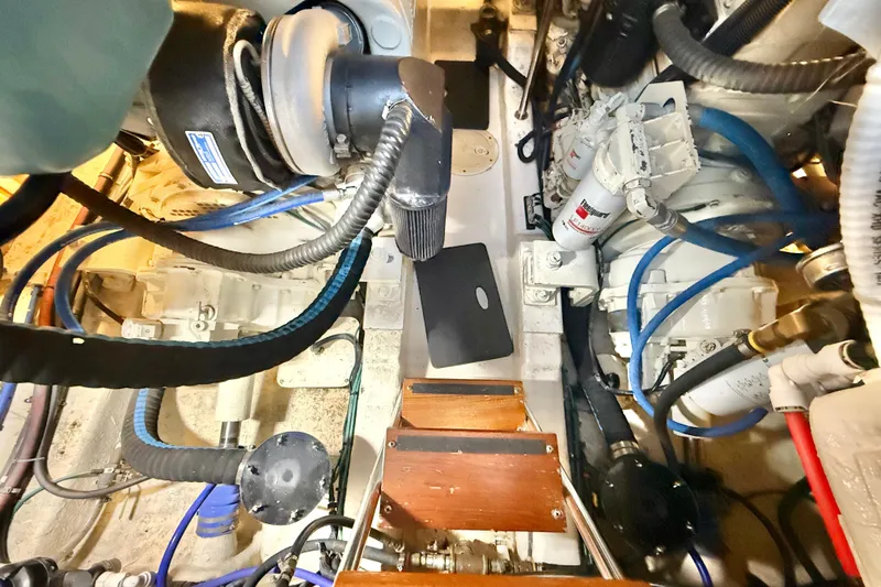 Slide: The Image of Engine room of 2001 Riviera 40 Flybridge with visible machinery and components. - 64