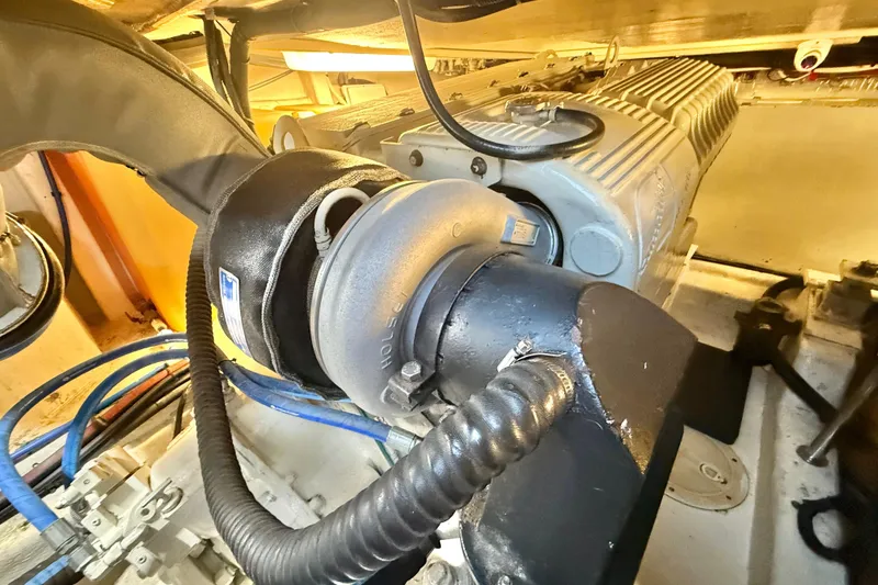 Slide: The Image of Engine room of 2001 Riviera 40 Flybridge, showcasing mechanical components and wiring. - 65